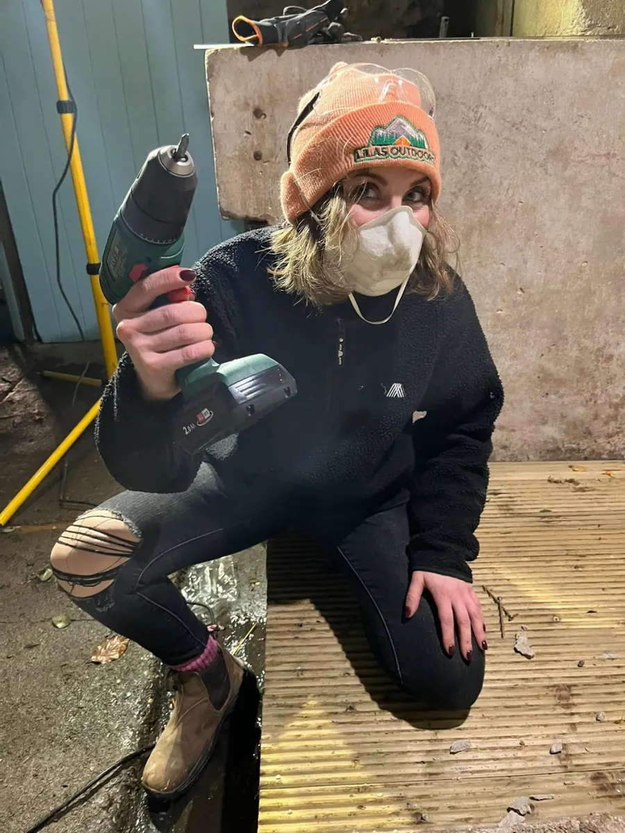Ready for demolition, drill in hand and dust mask on