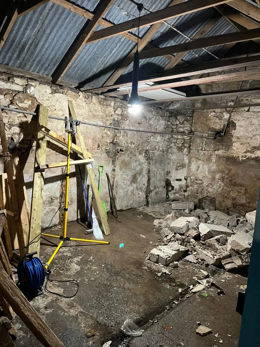 Old walls and stall partitions being knocked out inside