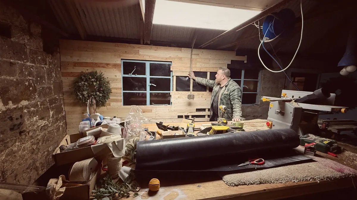 Cutting timber inside the shed