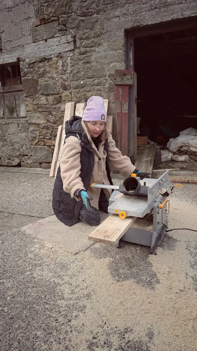 Cutting pallet wood with a saw outside