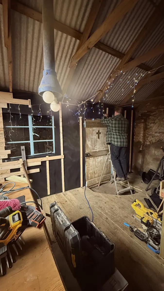 Old pallet wood cladding going up on the inside wall