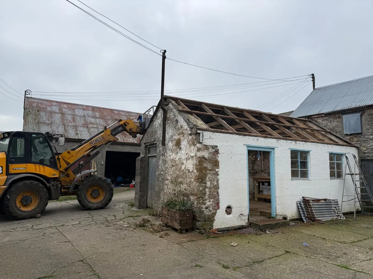The roof stripped back, with the loader alongside